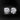 A pair of elegant round-cut diamond stud earrings set in silver-toned metal with four-prong settings.