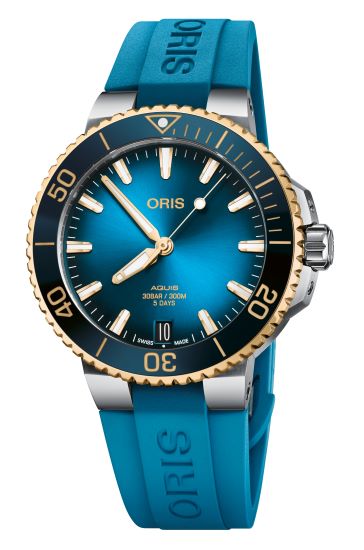 Blue and gold luxury dive watch with blue rubber strap and unidirectional bezel