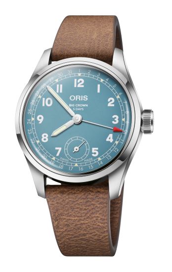 Men's luxury watch with blue dial, brown leather strap, and luminous hands