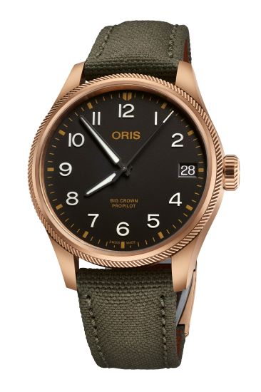 Bronze case aviation-style watch with black dial, date display, and green fabric strap