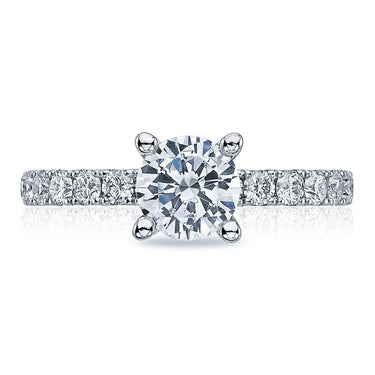 Round brilliant diamond engagement ring with pavé diamond band on white background