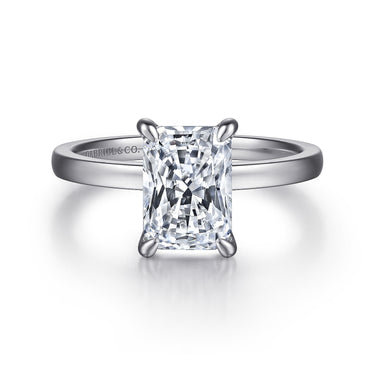 Radiant cut diamond solitaire engagement ring with a white gold band