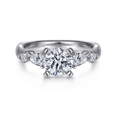 White gold engagement ring with round center diamond and side accent diamonds