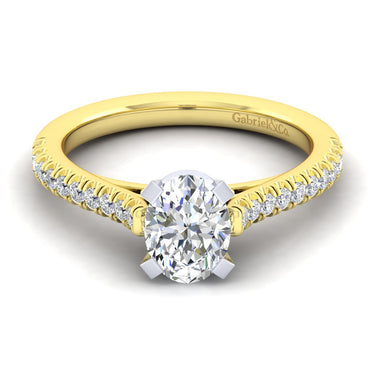 Oval diamond engagement ring with yellow gold band and pavé diamond accents