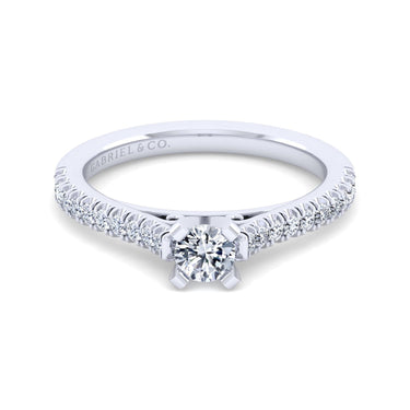 White gold engagement ring with round center diamond and diamond-accented band