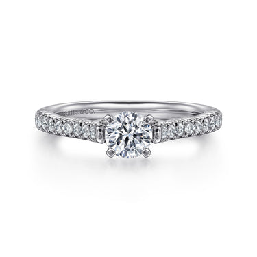 Round diamond solitaire engagement ring with pavé diamond band in white gold