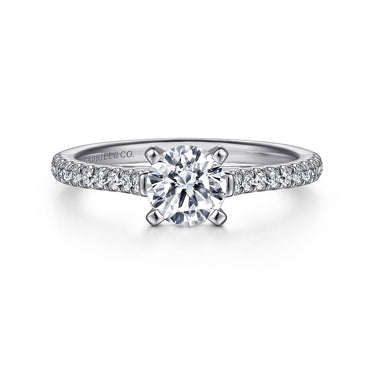 Round cut diamond engagement ring with pavé band in white gold, solitaire setting