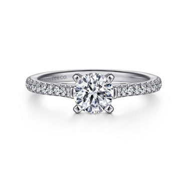White gold diamond engagement ring with round solitaire and pavé band