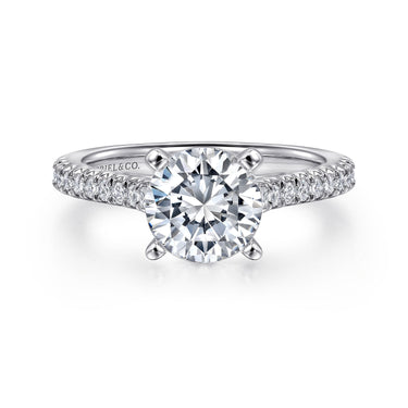 Round cut diamond engagement ring with pavé diamond band in white gold setting