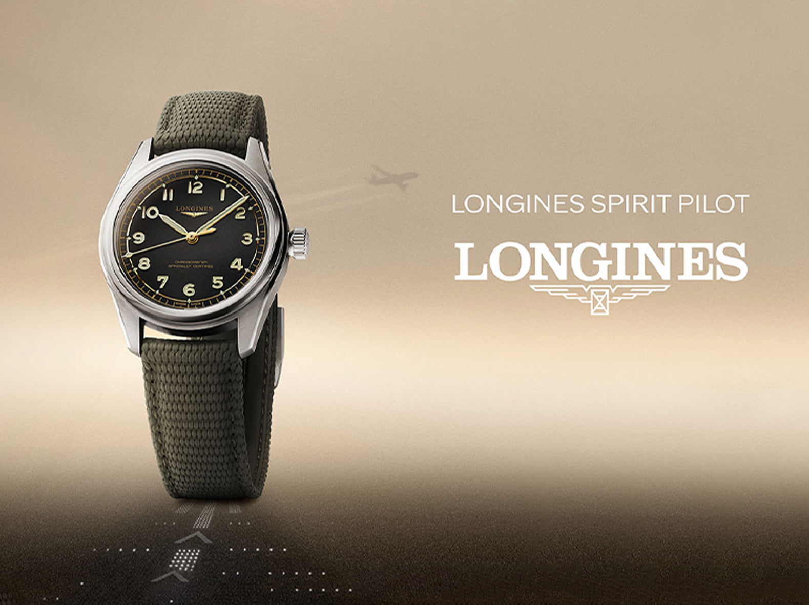 Longines Spirit Pilot watch with black dial and green fabric strap on beige background, airplane silhouette