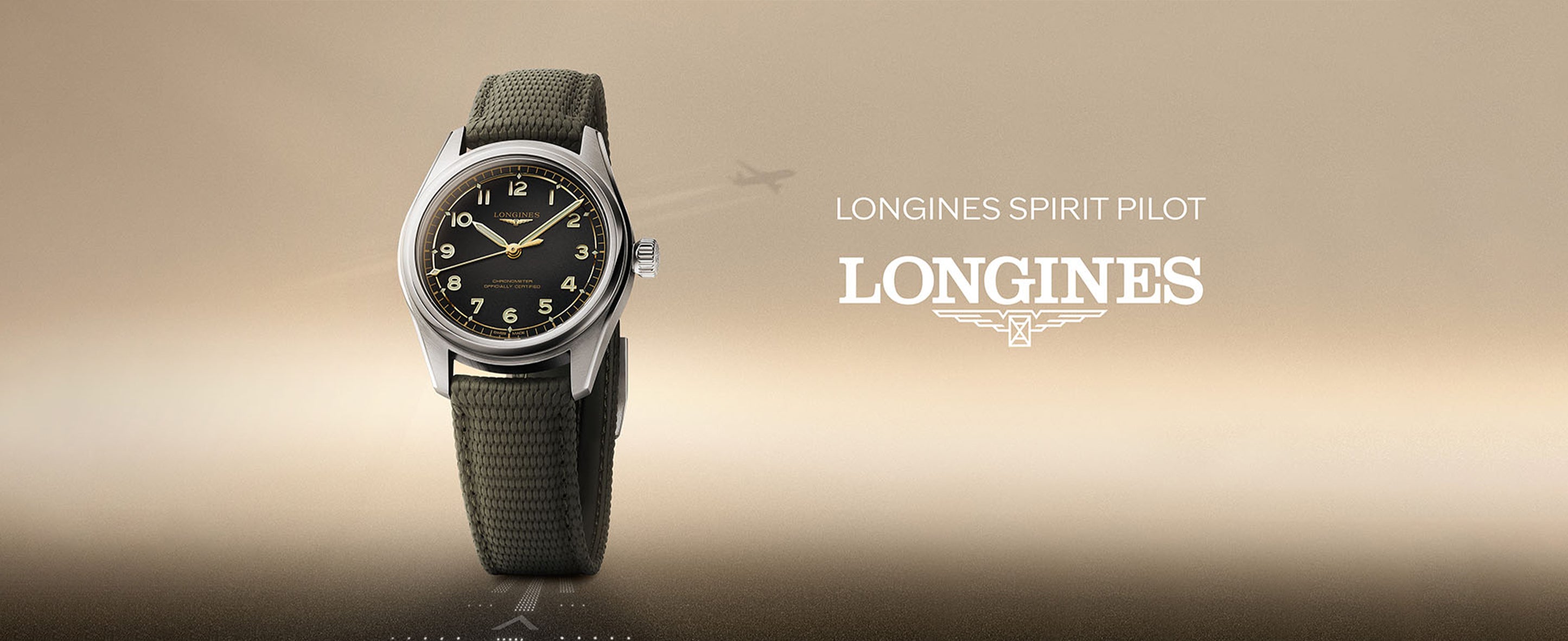 Longines Spirit Pilot men's watch with black dial and fabric strap on beige background