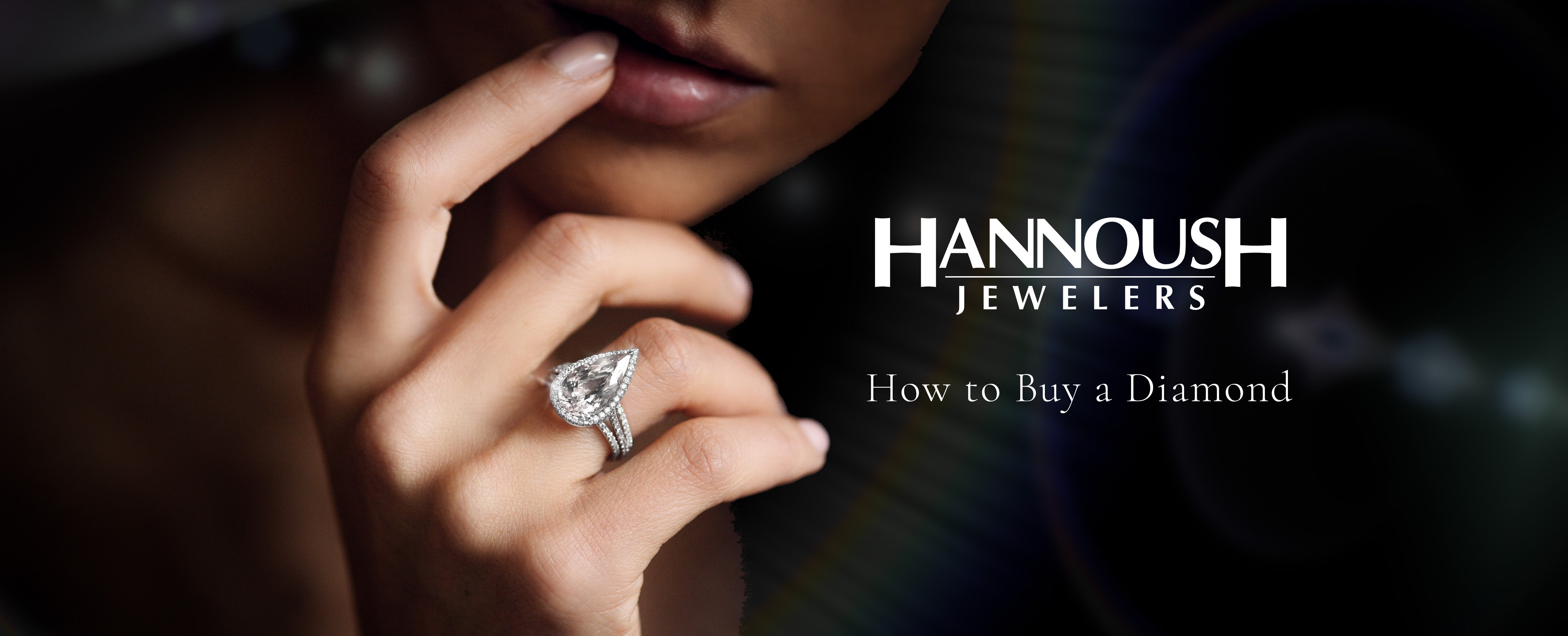 Close-up of woman wearing large pear-shaped diamond ring, with text 'How to Buy a Diamond'.