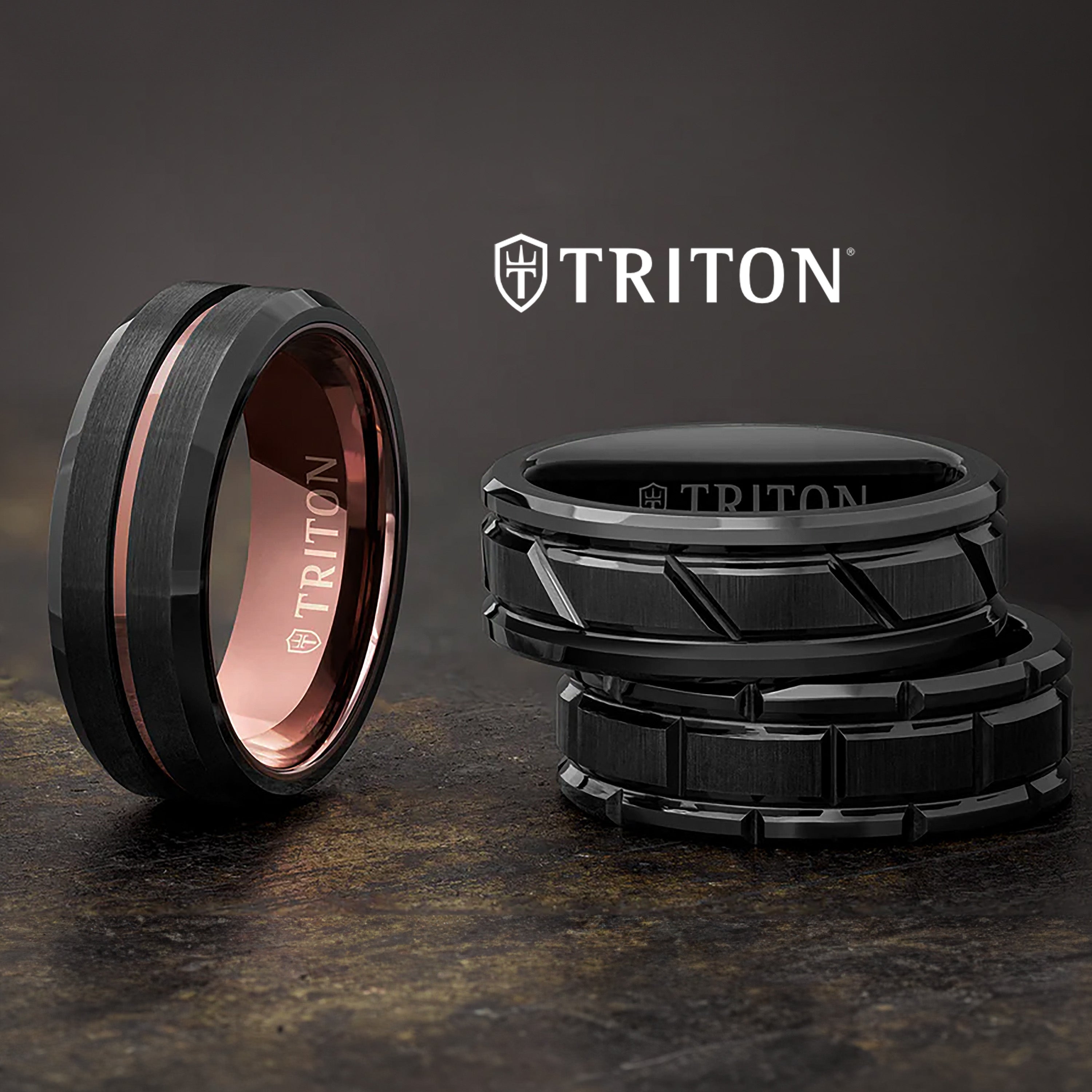 Men's black wedding bands with modern designs and metallic accents on a dark background