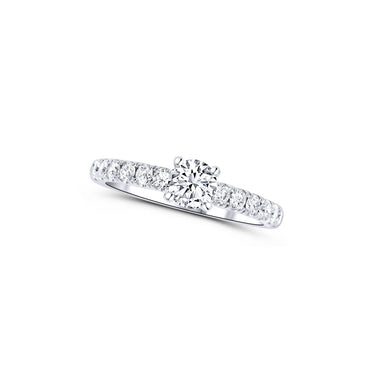 White gold diamond engagement ring with round solitaire and pavé band