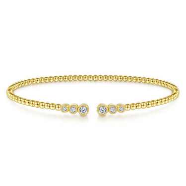 Yellow gold beaded cuff bracelet with bezel-set round diamonds on each end, fine jewelry