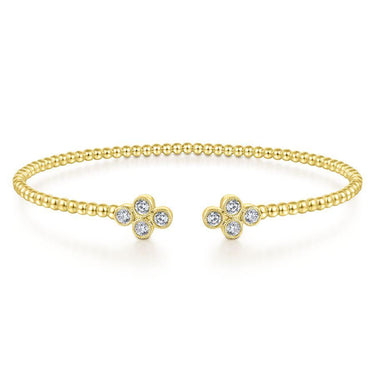 Yellow gold beaded cuff bracelet with diamond cluster accents on each end
