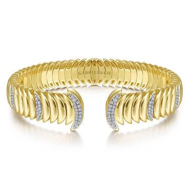 Gold cuff bracelet with curved textured links and diamond accents in the center.