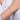 Diamond open bangle bracelet in white gold on wrist, elegant women's jewelry