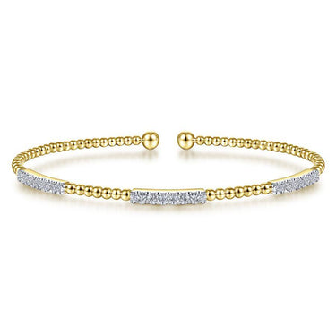 Gold beaded open cuff bracelet with diamond accents on a white background