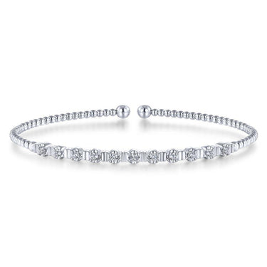 White gold diamond bangle bracelet with geometric detailing on a white background