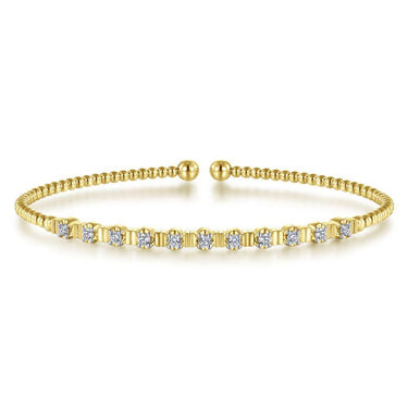 Yellow gold diamond station bangle bracelet with beaded design on white background