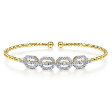 Gold beaded open bangle bracelet with diamond geometric links on white background