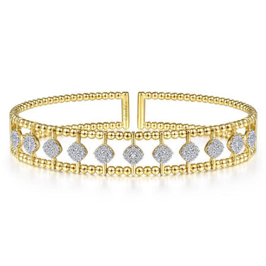 Yellow gold beaded bangle bracelet with diamond accents on a white background.