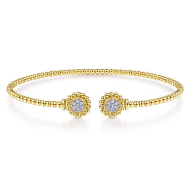 Gold beaded cuff bracelet with two round diamond floral accents on white background