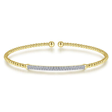 Gold beaded bangle bracelet with pavé diamond bar centerpiece on white background