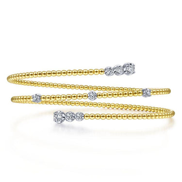 Yellow gold beaded wrap bracelet with round diamonds on white background