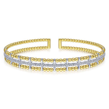 Yellow gold and white gold diamond cuff bracelet with beaded design on white background.