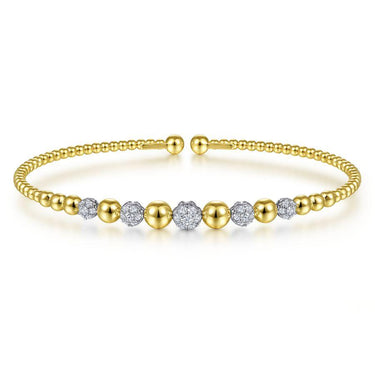 Gold beaded bangle bracelet with round diamond accents on white background