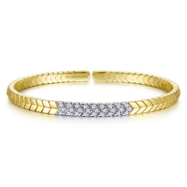 Yellow gold cuff bracelet with geometric diamond accents on front, elegant jewelry design