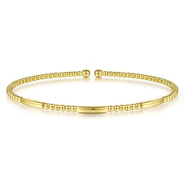 Elegant yellow gold beaded cuff bracelet with smooth bar accents on white background