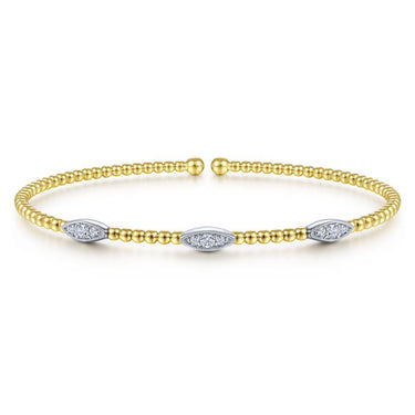 Gold beaded cuff bracelet with three marquise-shaped diamond accents on white background
