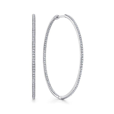 Large white gold hoop earrings with pavé set diamonds on a white background