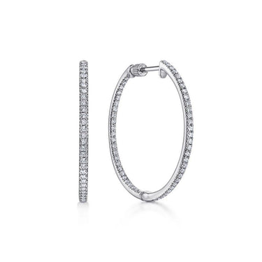 Large white gold hoop earrings with sparkling pavé set diamonds on white background