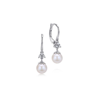 White gold drop earrings with round pearls and diamond accents on a white background