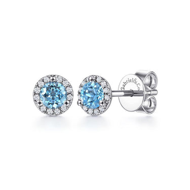 Blue gemstone stud earrings with diamond halo in white metal setting