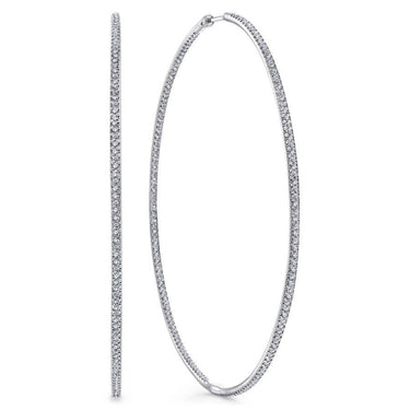 Large white gold hoop earrings with pavé-set diamonds, fine jewelry close-up