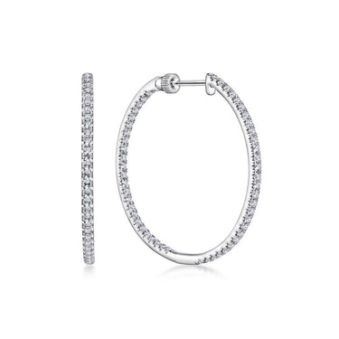 White gold oval hoop earrings with pavé set round diamonds on white background