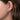 Diamond floral stud earring in white gold on woman's ear, fine jewelry close-up