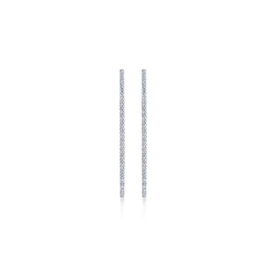 Pair of slim white gold diamond stick earrings on white background