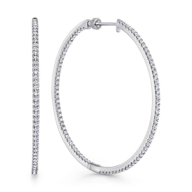 Large white gold hoop earrings with pavé set round diamonds, displayed on white background.