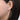 Large diamond hoop earring in white gold worn on ear, fashion jewelry close-up