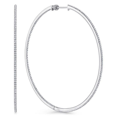 Large white gold diamond hoop earrings with a row of sparkling pavé stones