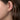 Gold huggie hoop earring with pavé diamonds on a woman's ear