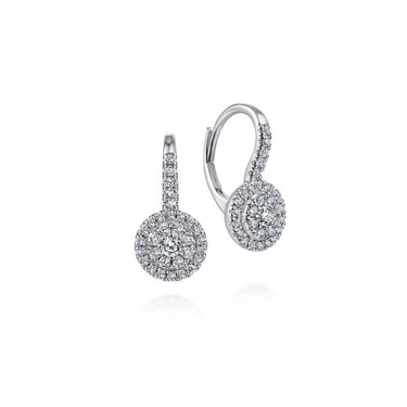 White gold dangle earrings with round halo pavé diamonds on a white background