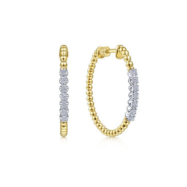 Yellow gold hoop earrings with round diamond accents and beaded detailing, on white background