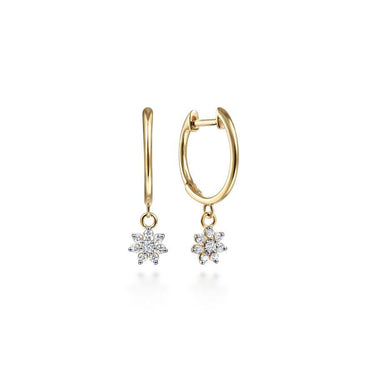 Gold hoop earrings with diamond flower dangle on white background